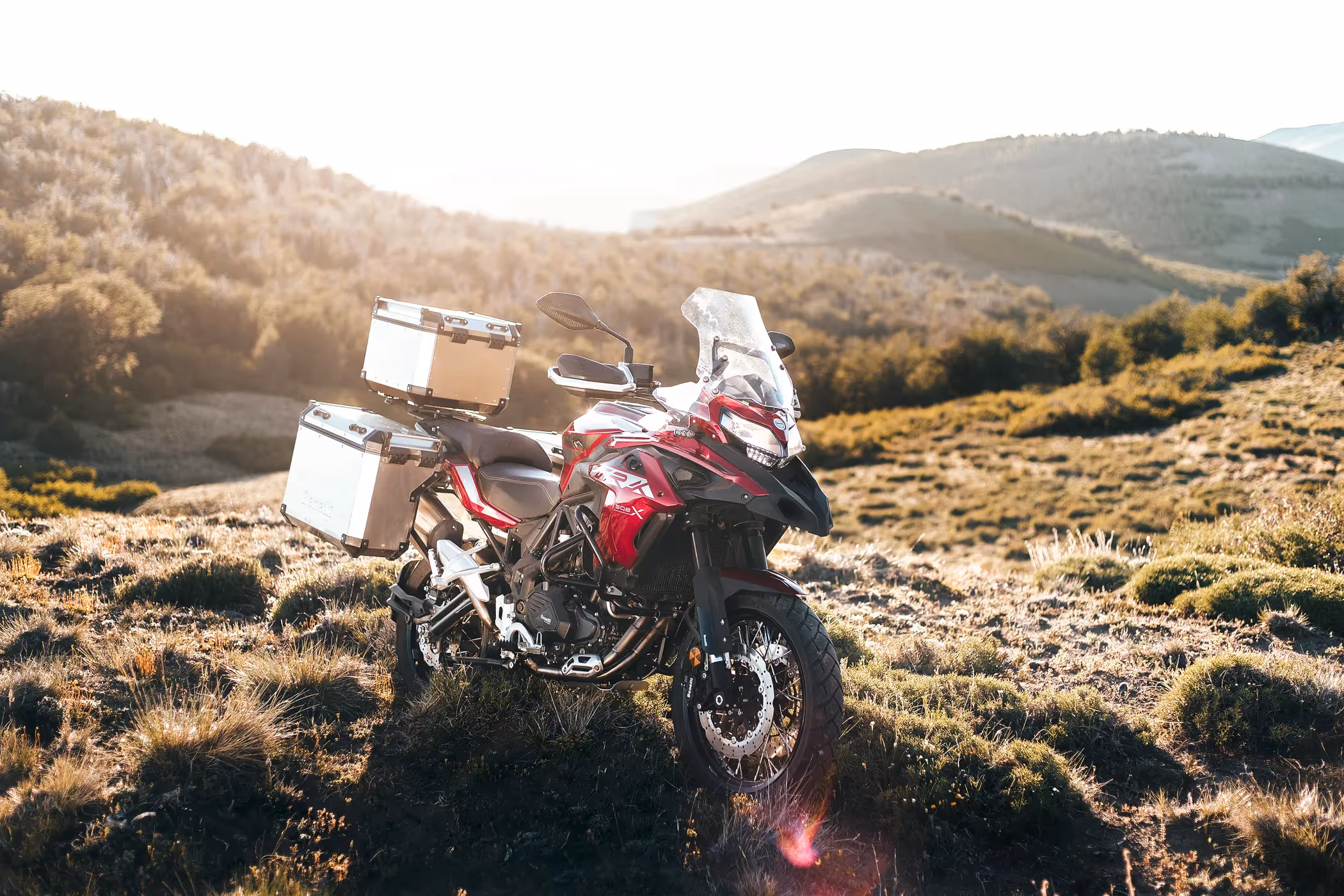 A Benelli TRK 502X is under morning sunshine on a mountain slope