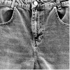 Close-up of the front of blue denim jeans showing button, zipper, and pockets.