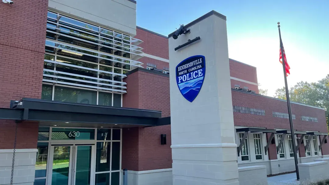 Hendersonville Police Department headquarters building with its police sign and American flag