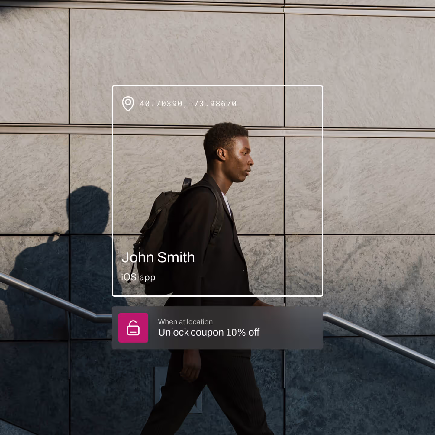 A man in business attire with a backpack walks past a modern stone wall in the late afternoon sun. A digital overlay displays his name—John Smith—and identifies him as an iOS app user. A promotional prompt offers a 10% off coupon when detected at a specific location, emphasizing geo-targeted marketing.