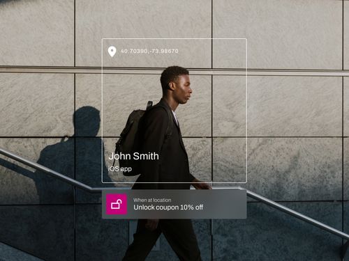 Man walking by a tiled wall with an app interface showing location coordinates and a 10% off coupon unlock notification.