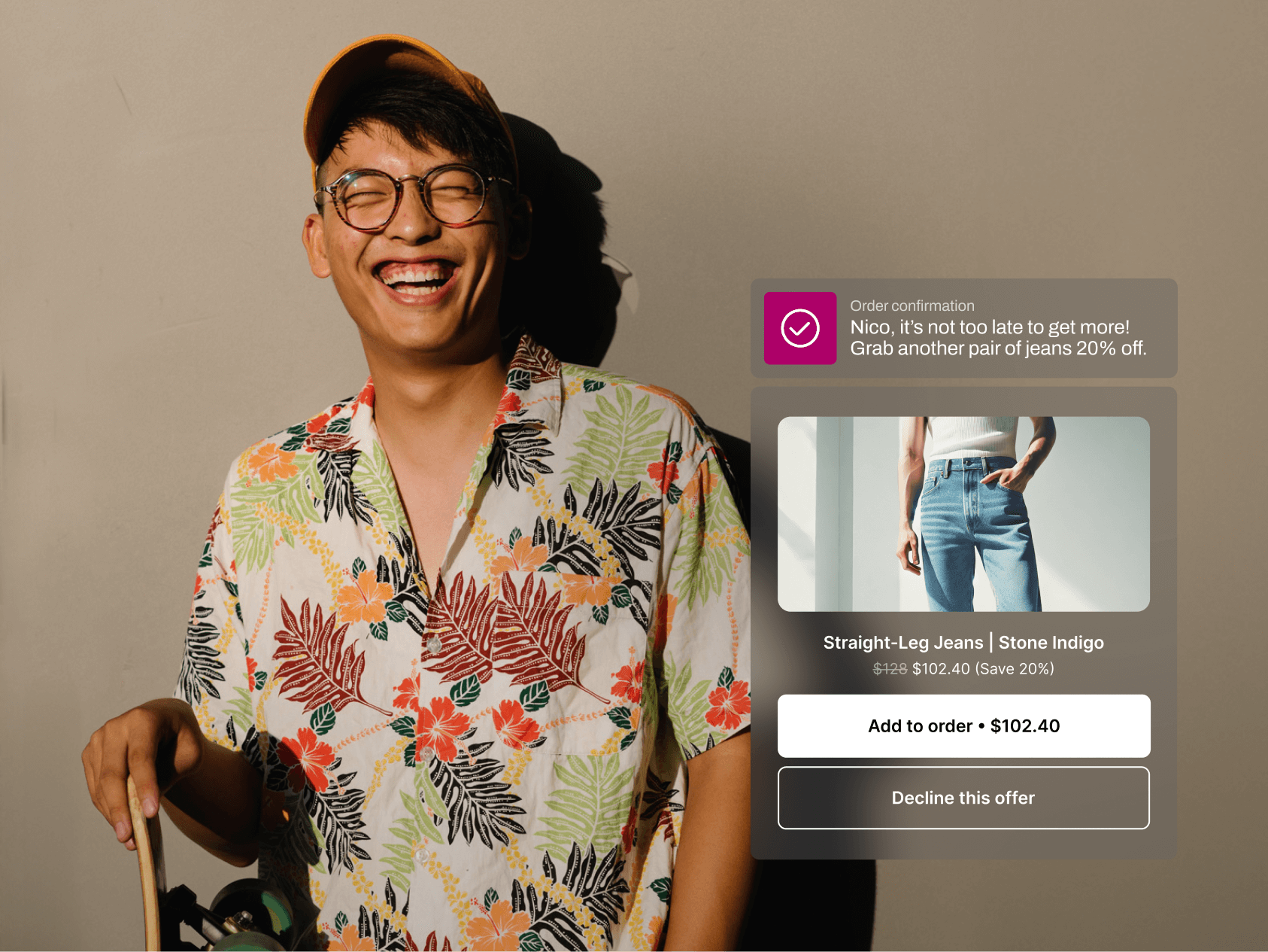 A smiling man in a floral shirt and orange cap leans against a wall holding a skateboard, bathed in warm sunlight. A notification says, “Nico, it’s not too late to get more!” offering him a 20% discount on a second pair of jeans. A product card below displays “Straight-Leg Jeans | Stone Indigo” with the discounted price and buttons to add the item or decline.