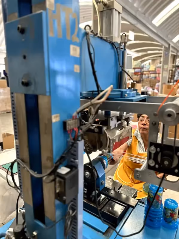 Sharp Plastics - picture of a machine from the back with a worker working on it