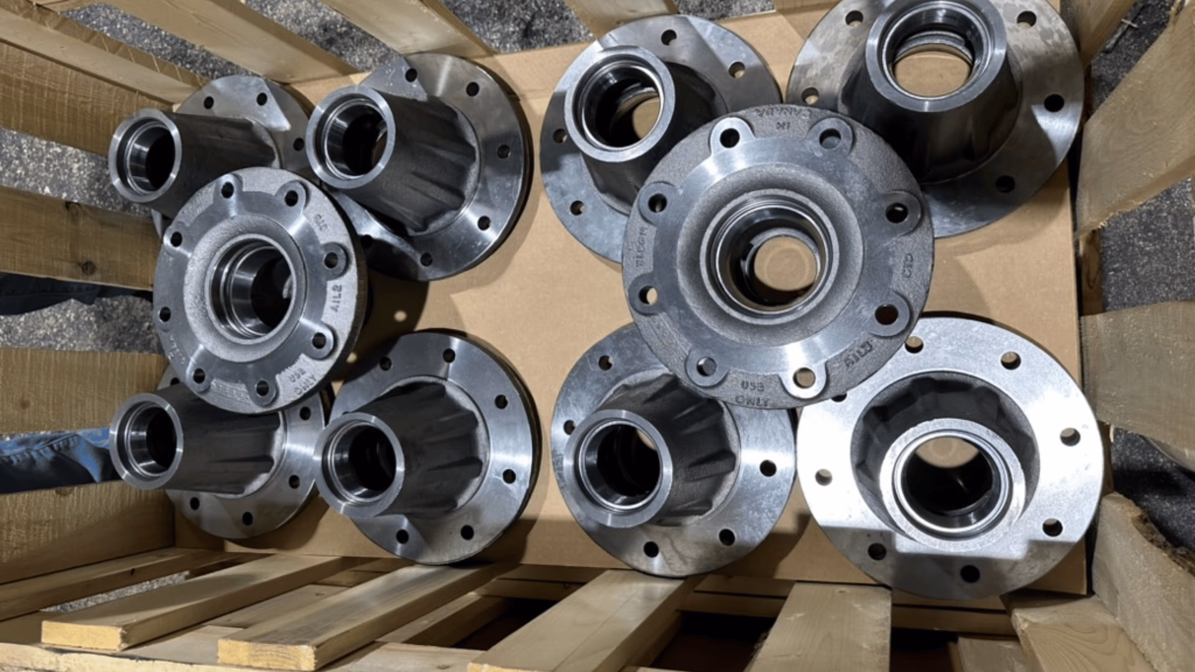 A box of round metal parts stacked neatly