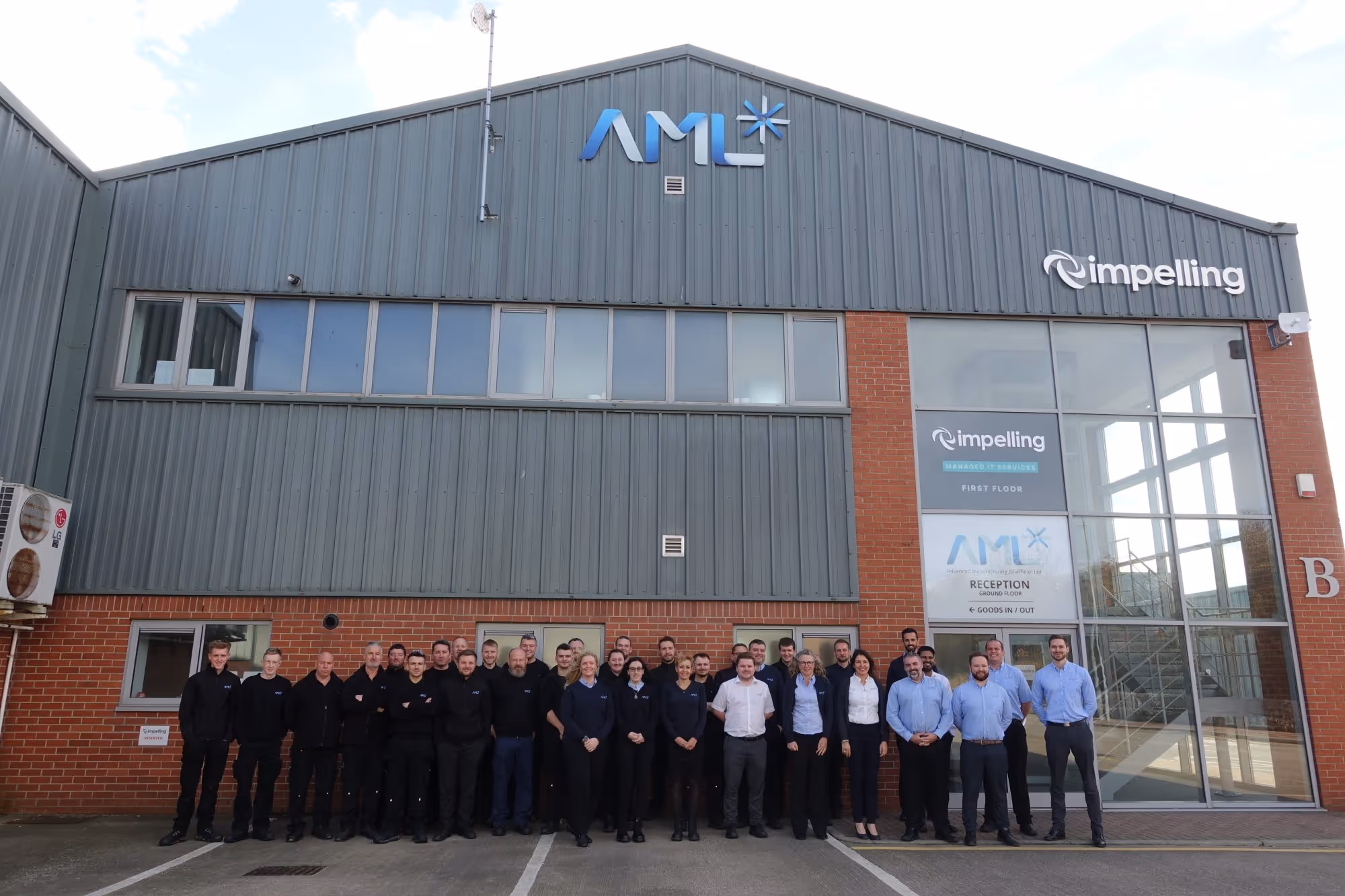 The AML team standing in front of their new expansion