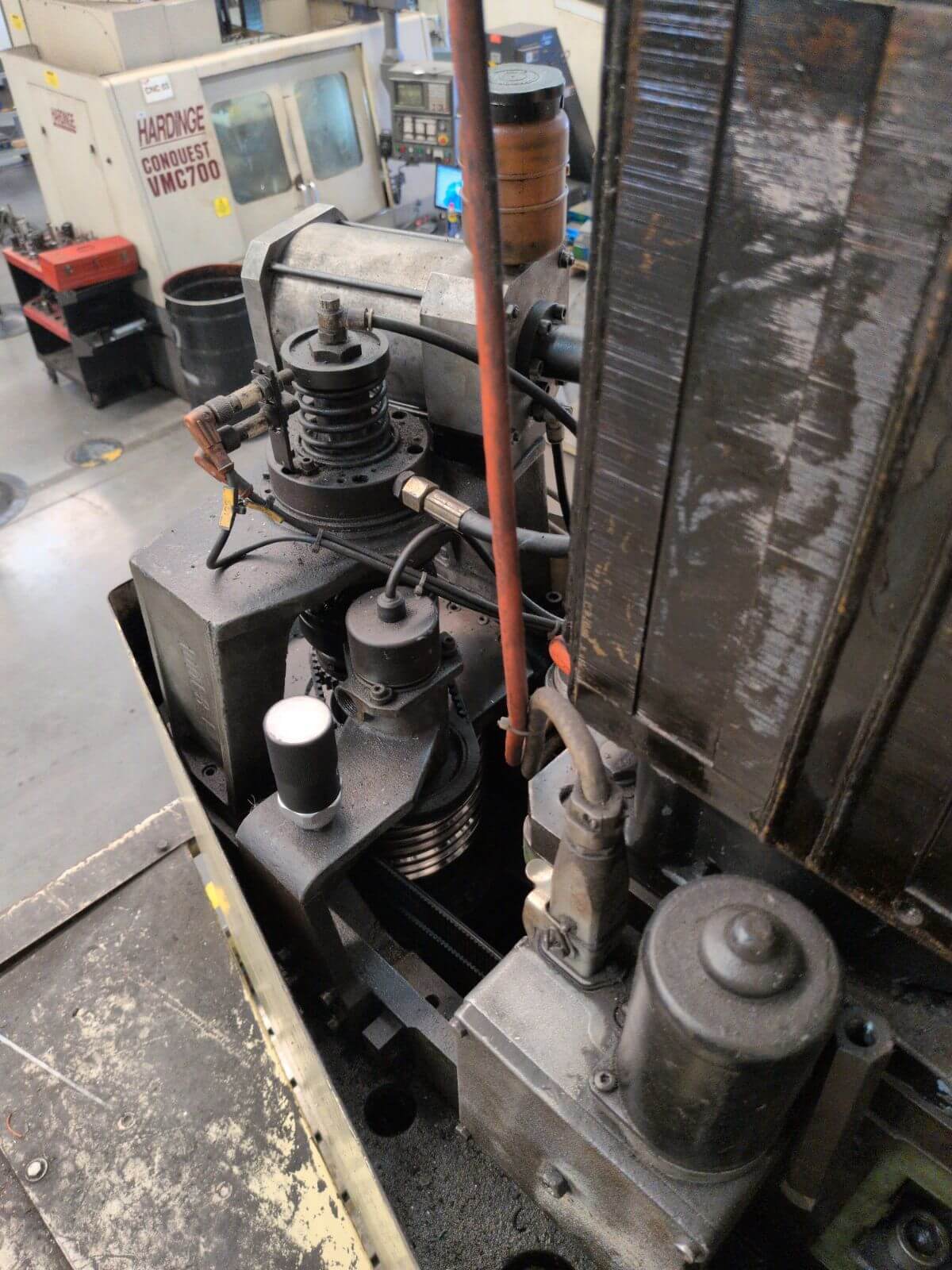 SensFlo monitoring sensor mounted near the drive and pulley assembly of a legacy machine tool.