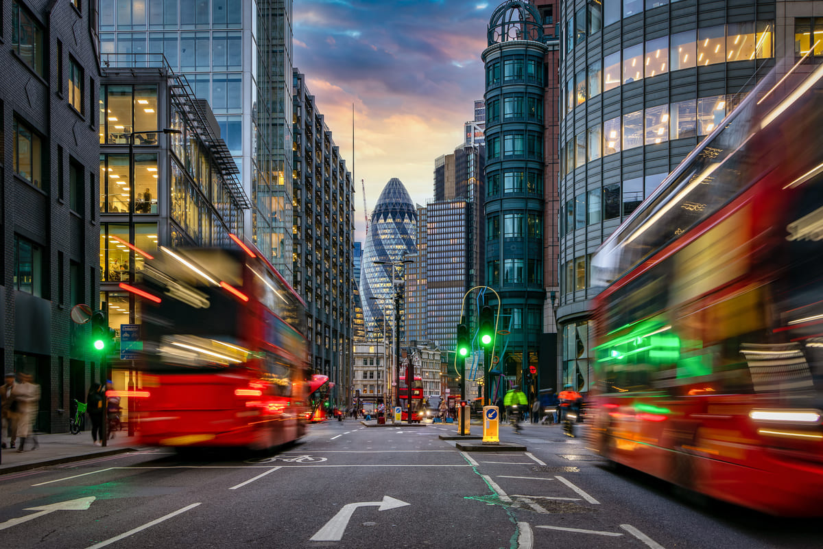 An image of a City of London street with red buses.