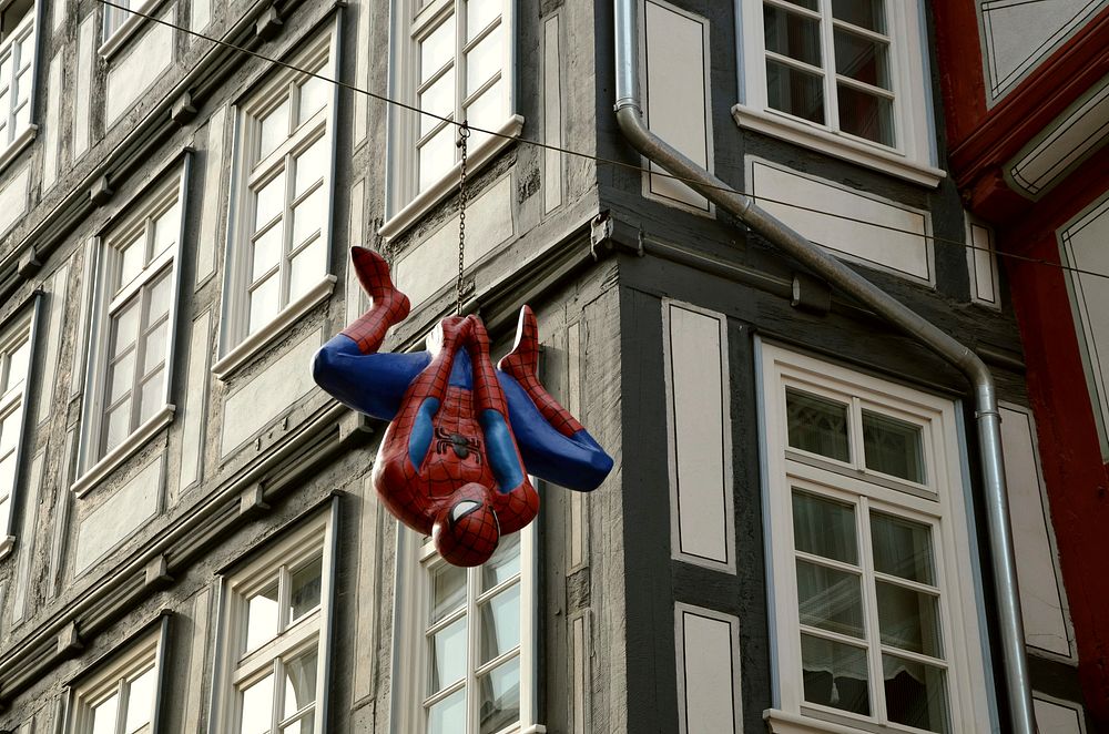 Actor in a Spider-Man costume performing a stunt on a film set for costume and OTT studios.