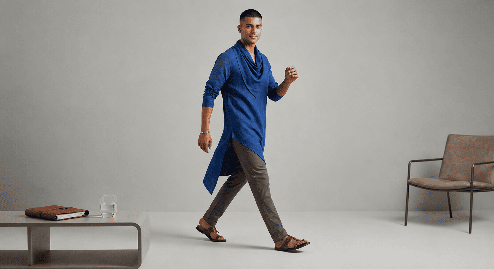 Modern asymmetric linen kurta for men featuring contemporary diagonal hemlines and draped silhouettes.