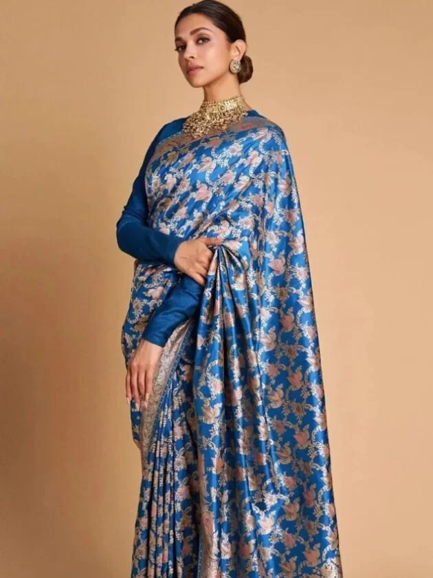 Deepika Padukone wearing a traditional Blue saree demonstrating Bollywood fashion trends in India