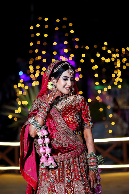 Traditional red Sabyasachi inspired bridal lehenga showcasing Indian wedding fashion