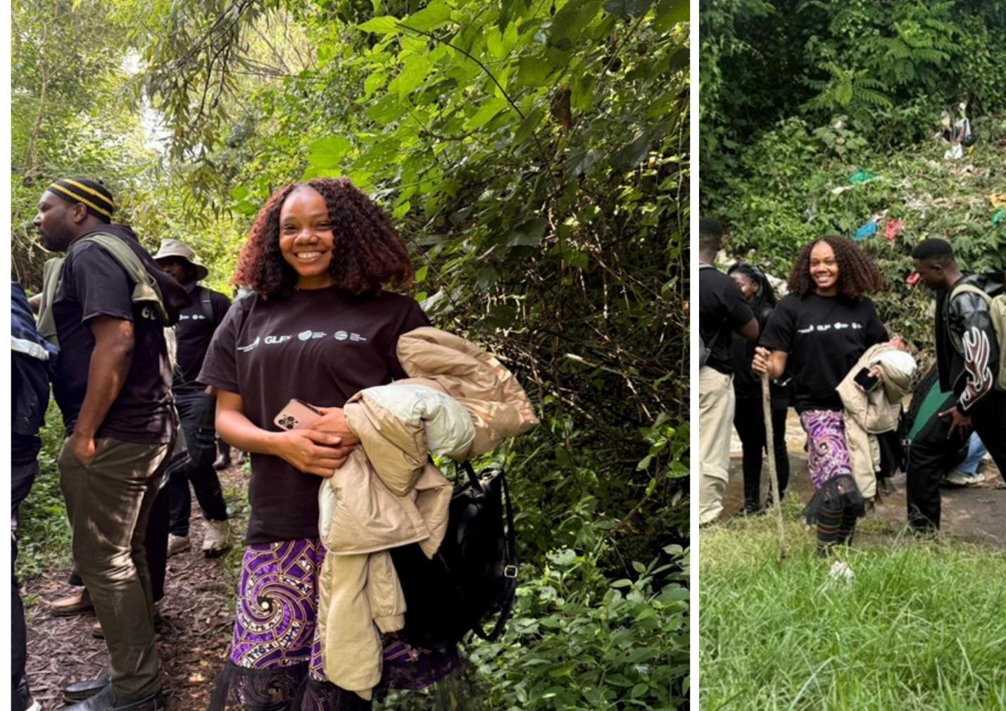 The image shows a person dressed in a black shirt and a patterned dress, holding a child and others, surrounded by greenery and bushes, while another person walks with a backpack.AI-generated content may be incorrect.