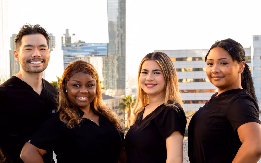 The city of angels dentistry team smiling together as a group, showcasing professionalism and warmth