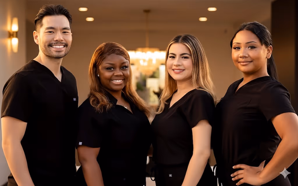 Dr. Kevin Chin and his team smiling together, showcasing warmth,  care, and happy smiles