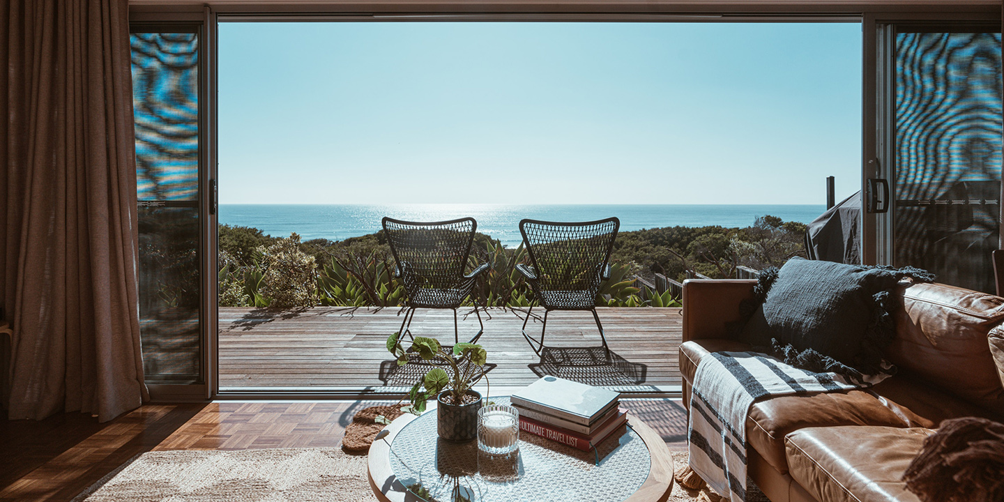 living room with a forest and ocean view