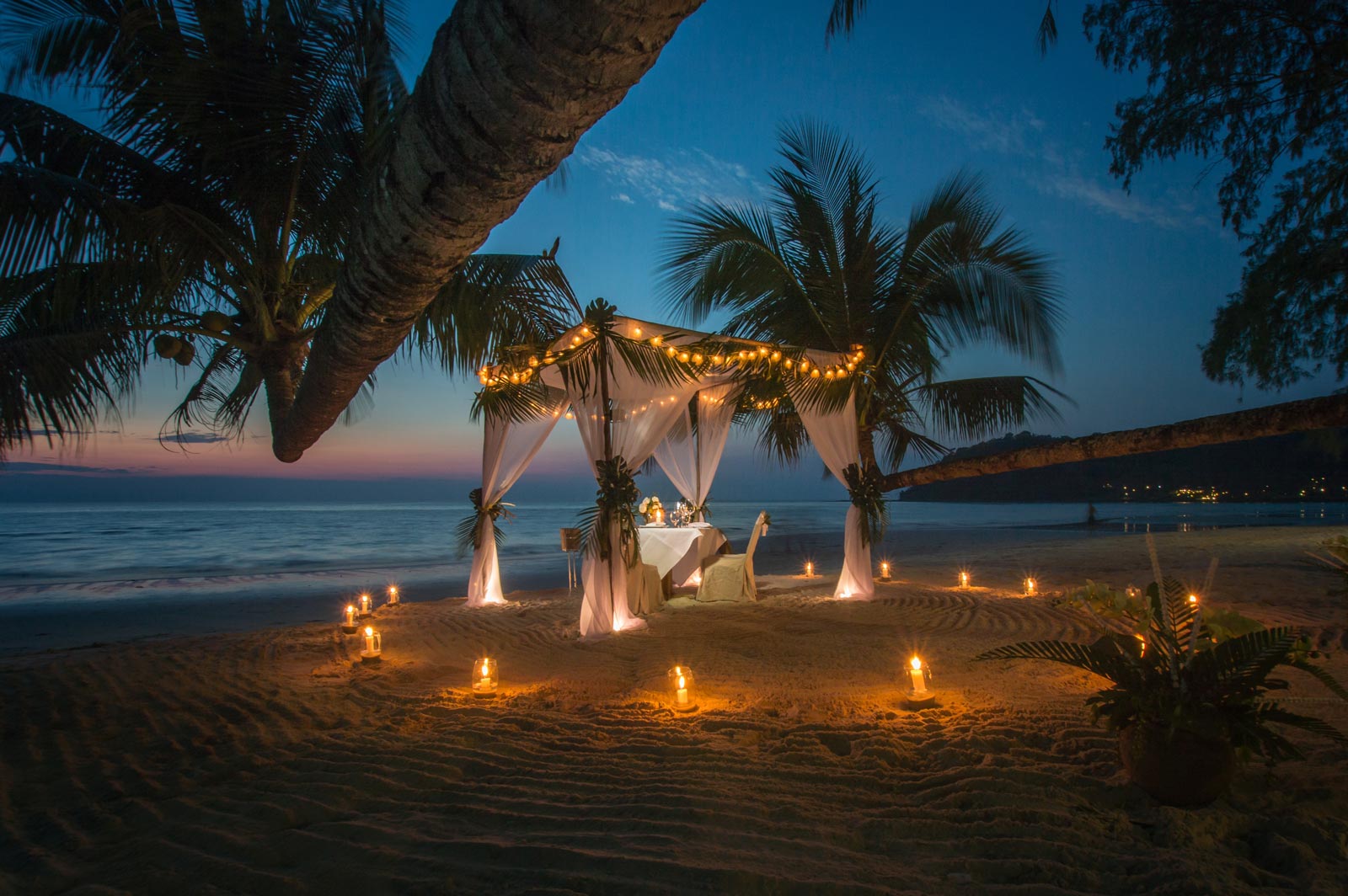dinner set up at night by the beach