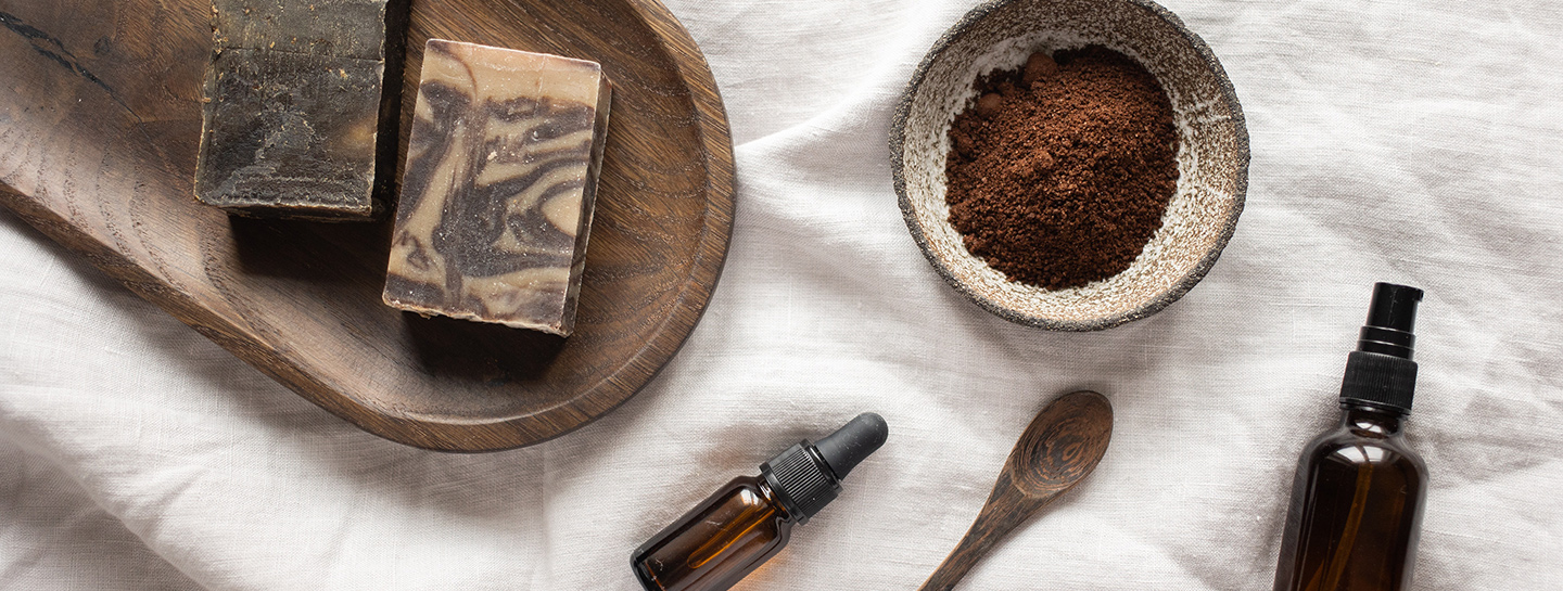 Massage essentials on top of wooden board and bed