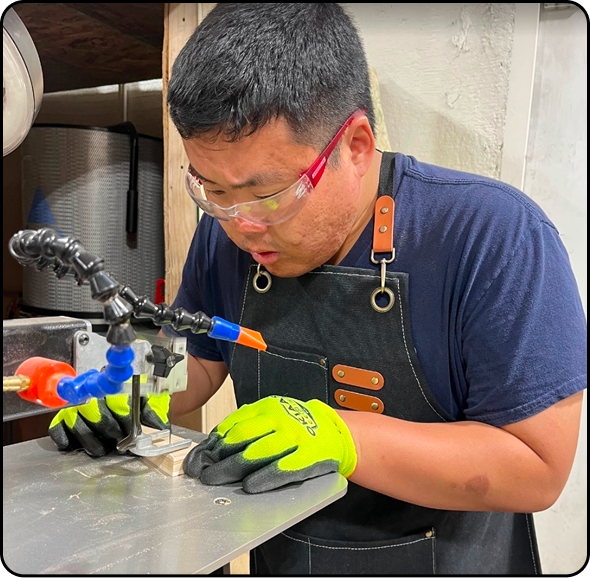 A teacher and a student looking at welding work