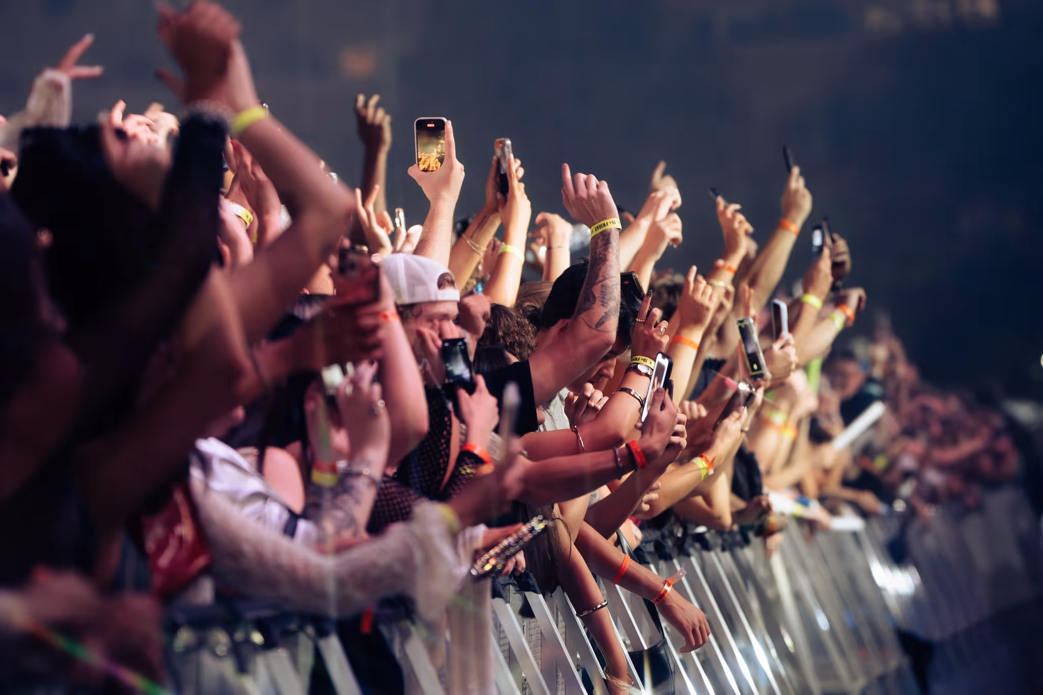 Crowd reaching toward the stage at the front barricade at night, Magnetic World Music Festival, Halifax