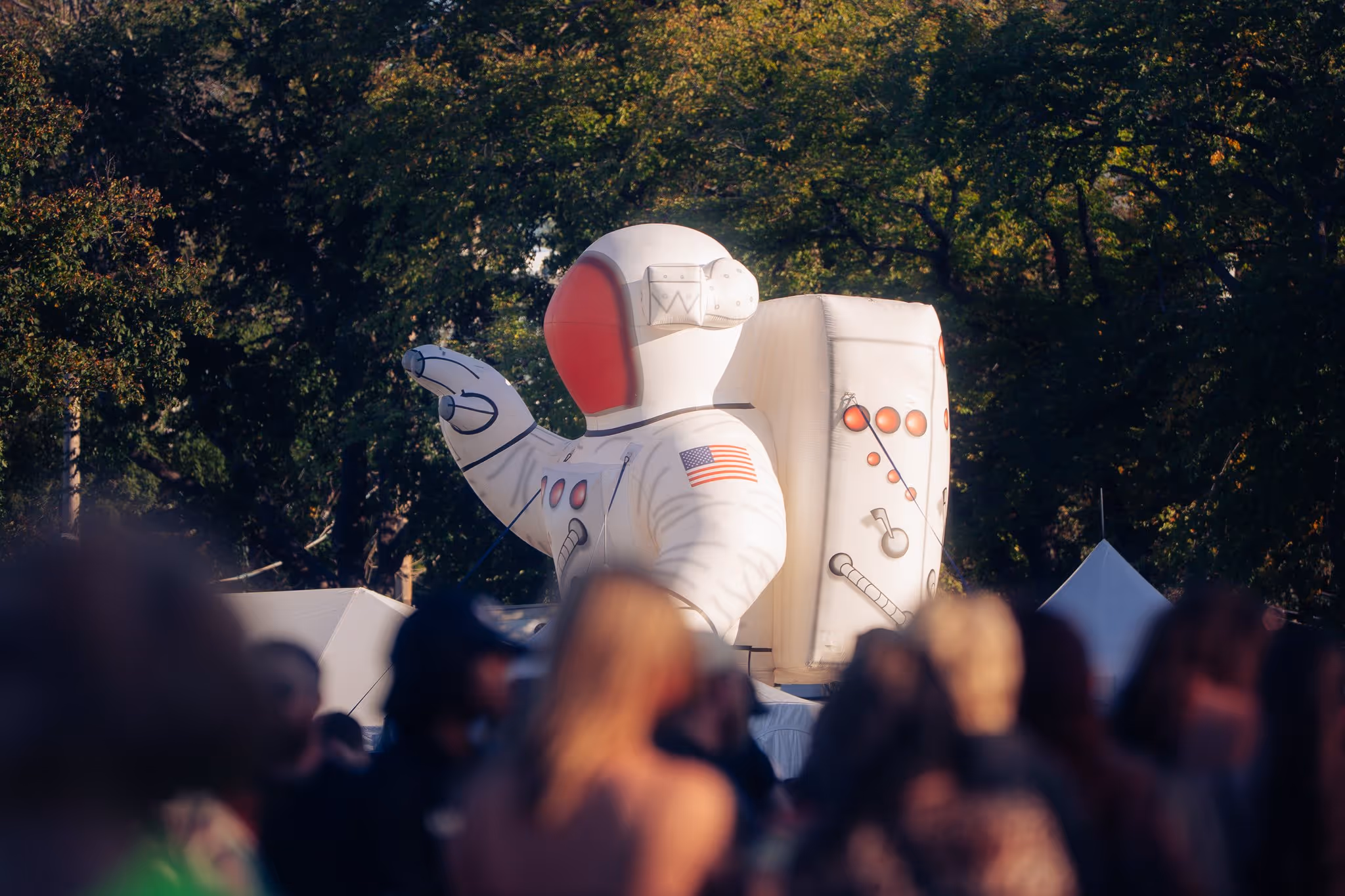 Giant inflatable astronaut towering over the crowd at golden hour, Magnetic World Music Festival, Citadel Hill, Halifax