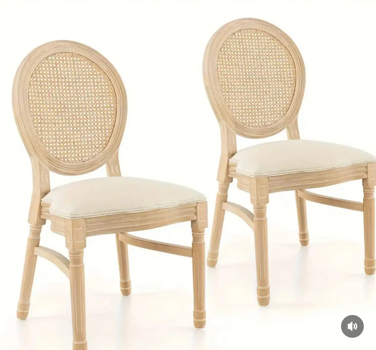 Two elegant chairs featuring rattan backs and white upholstery, perfect for event rentals.