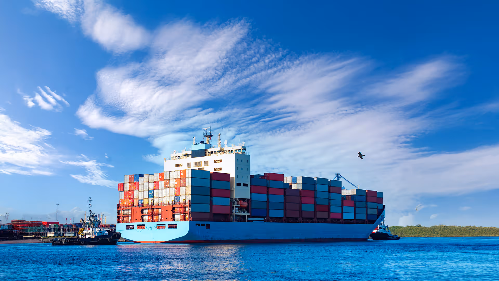 Loaded container ship. Ship with colorful containers on Board. Shipping. Transportation of goods by sea.Container ship and tug in the sea commercial port.