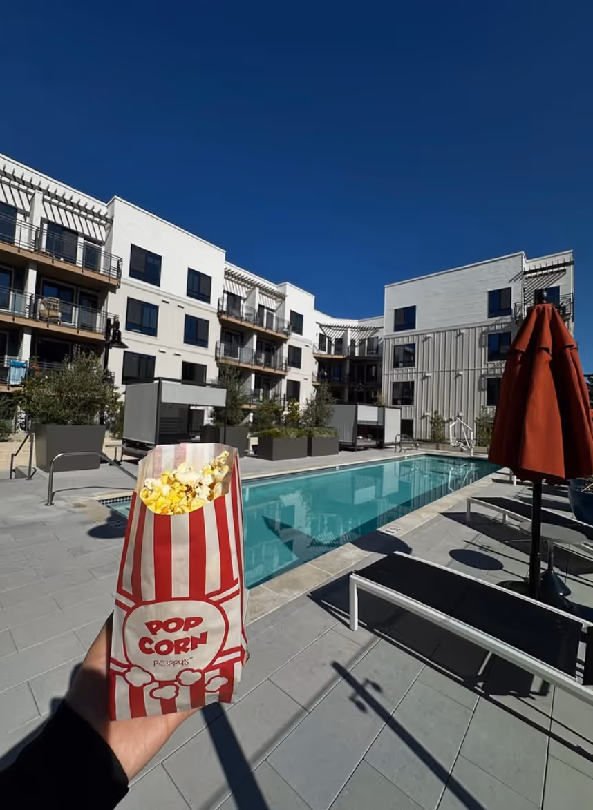 A pool with someone holding popcorn