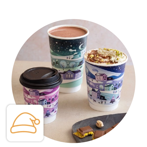 Trio of hot drinks in festive Christmas cups and packaging.