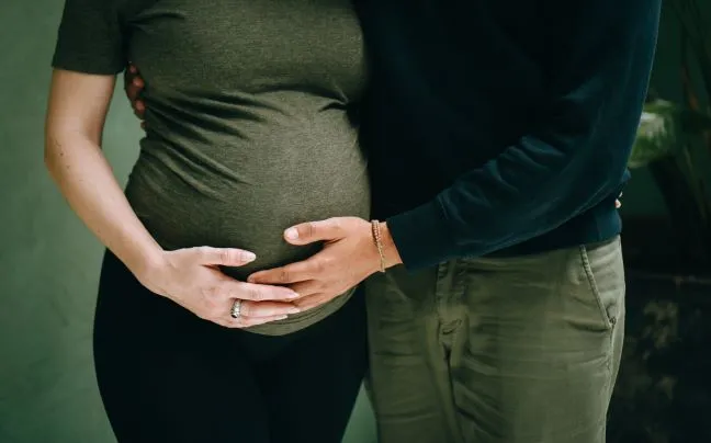 Expecting couple holding the pregnant belly