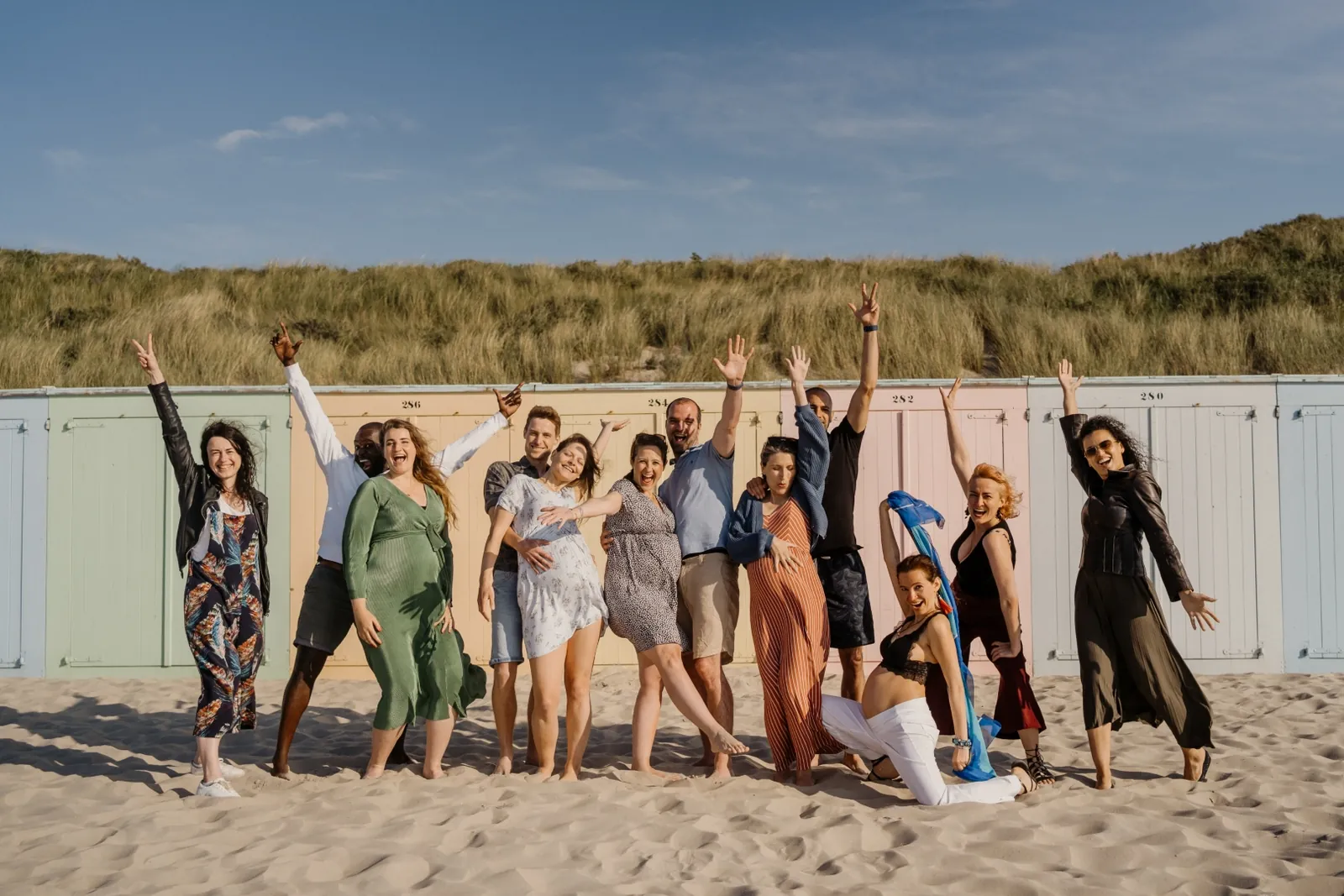 Mamamoon pregnancy retreat group celebrating on the beach