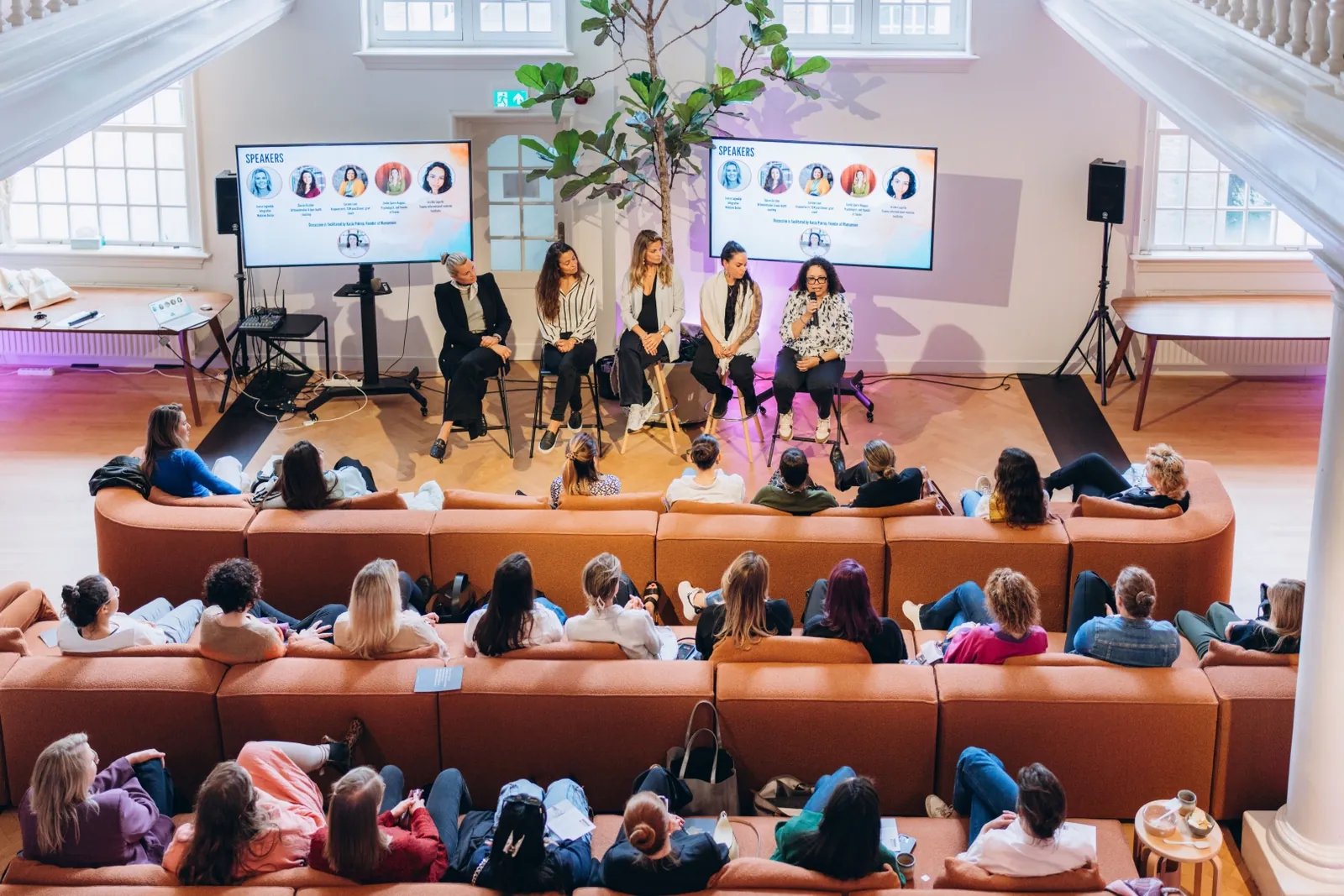 Audience watching a panel at a Mamamoon event