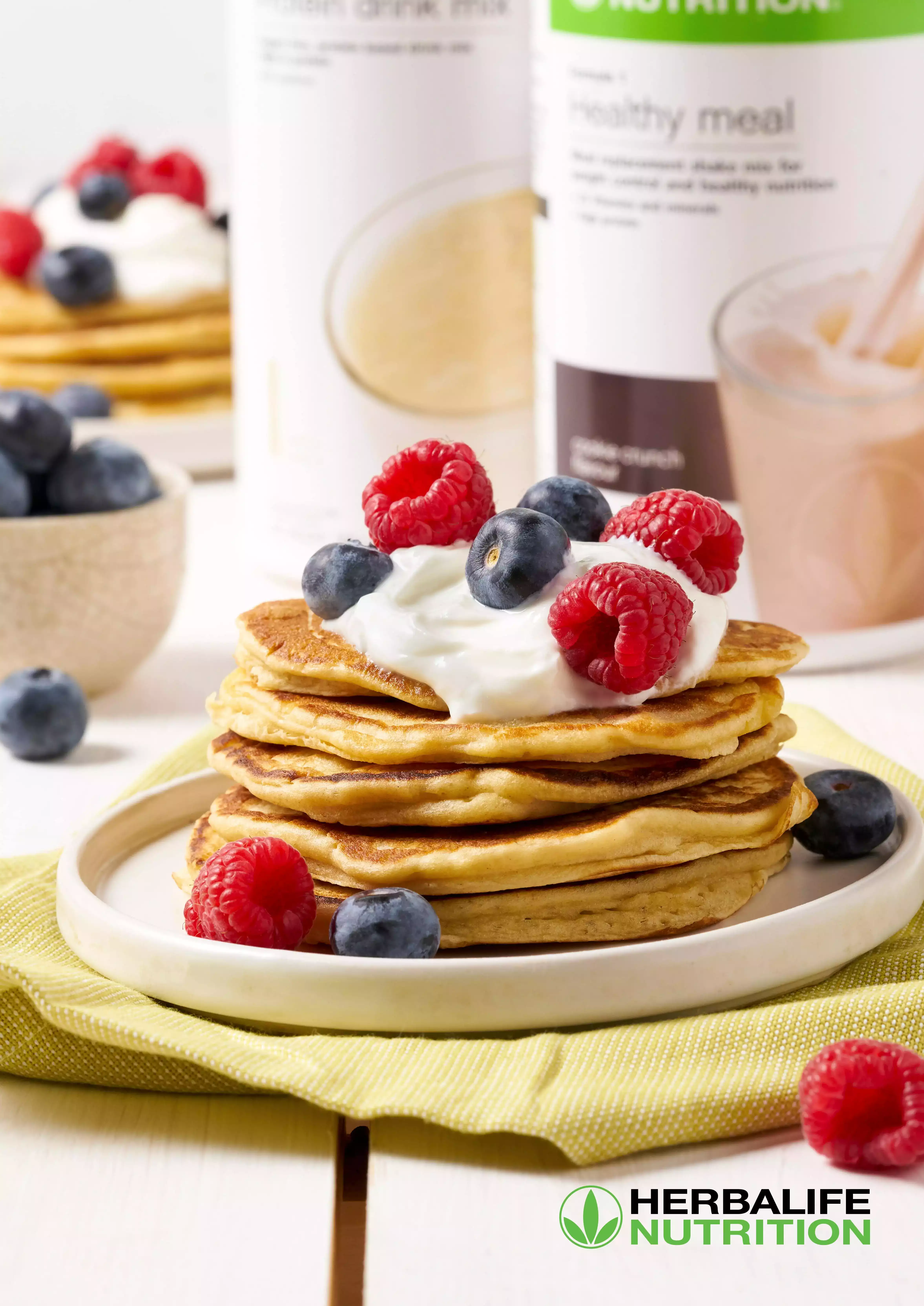 Image de plusieurs pancakes de thé avec un flacon d'un produit Herbalife
