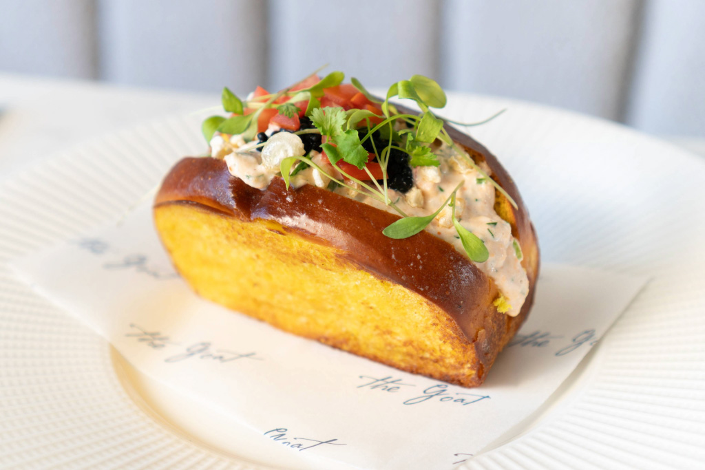 Image of parsnip risotto with a glass of wine on a marble table