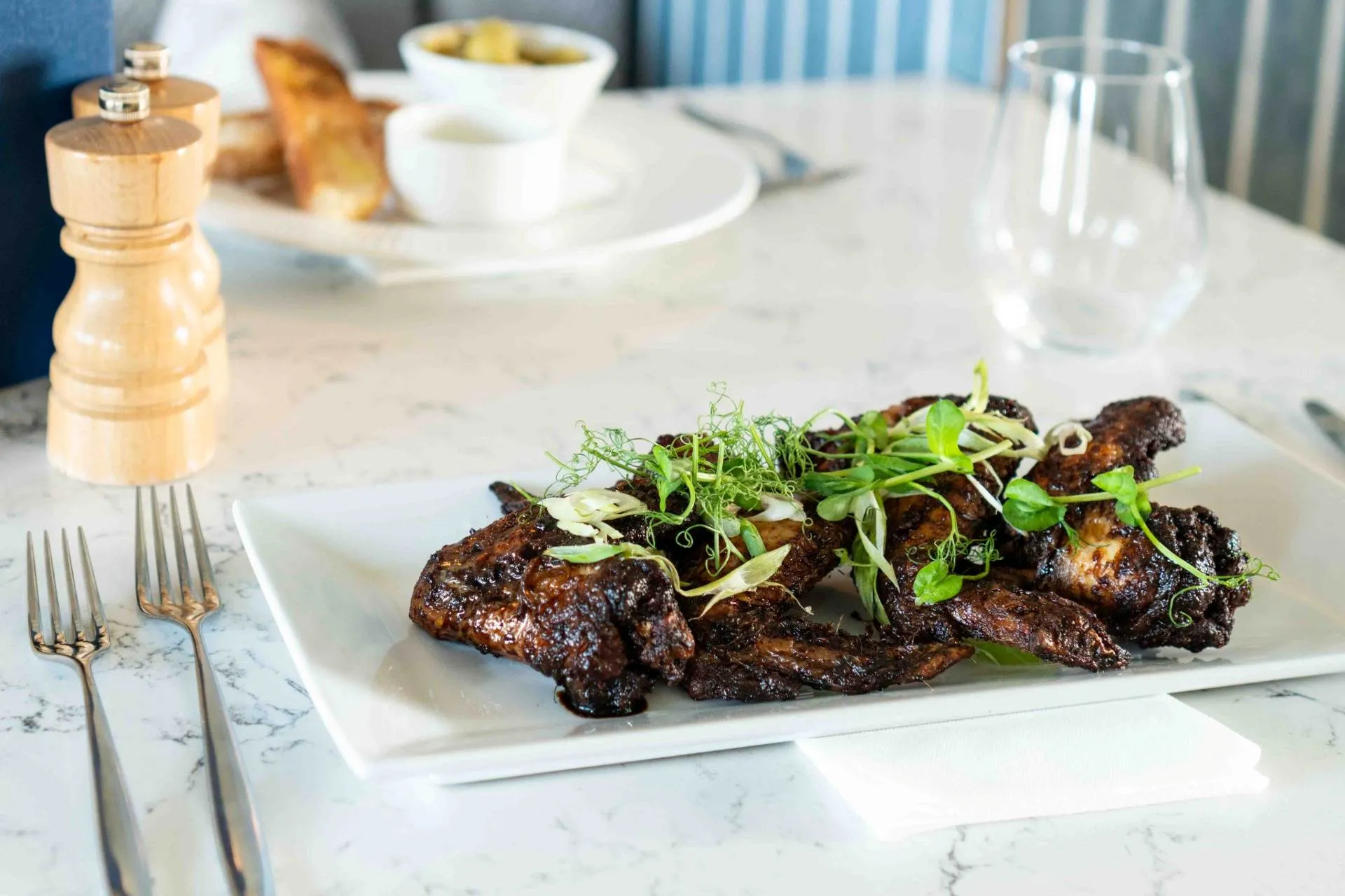 Honey and soy glazed chicken wings topped with fresh cress at The Goat, Llandudno