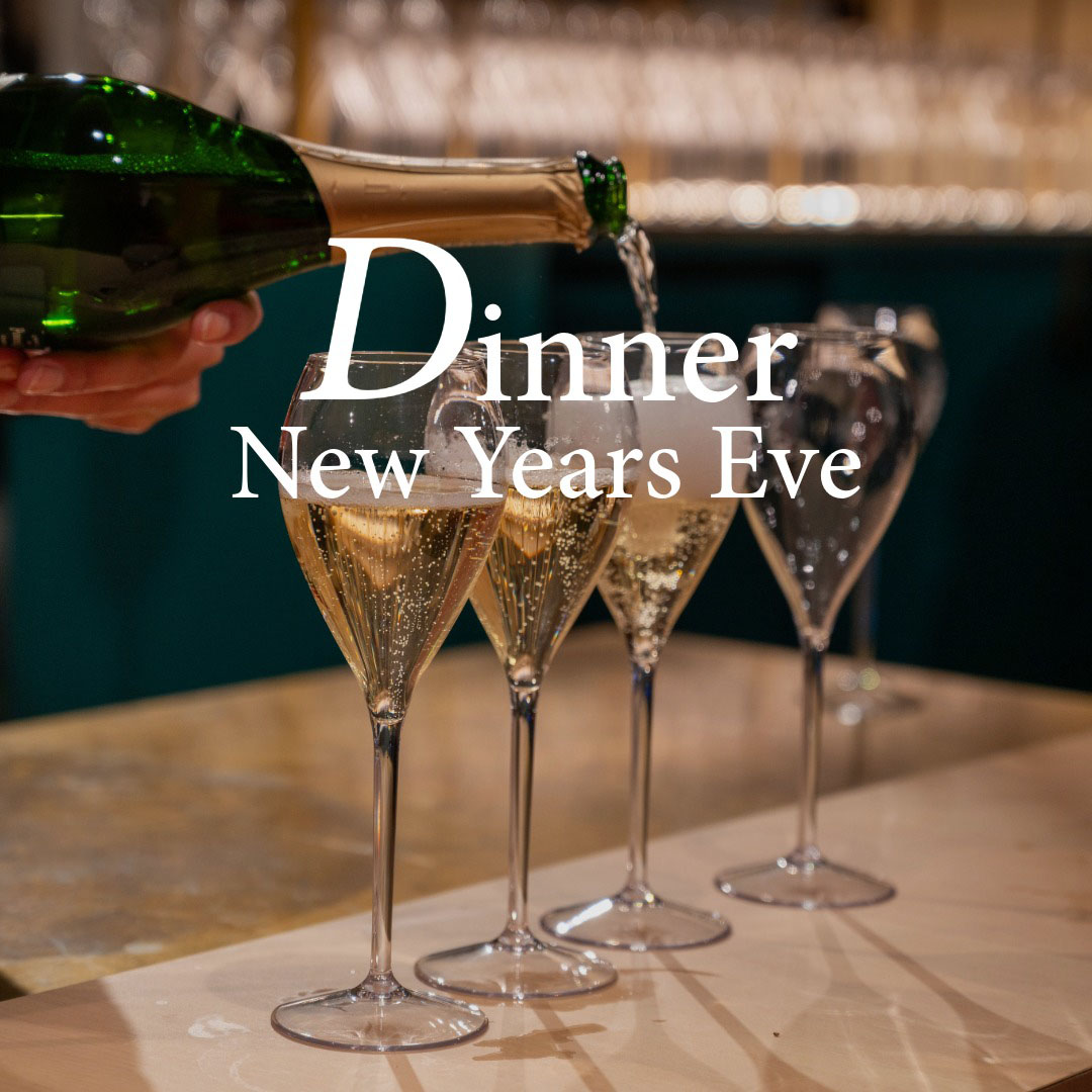 Champagne being poured into glasses for New Year's Eve dinner.