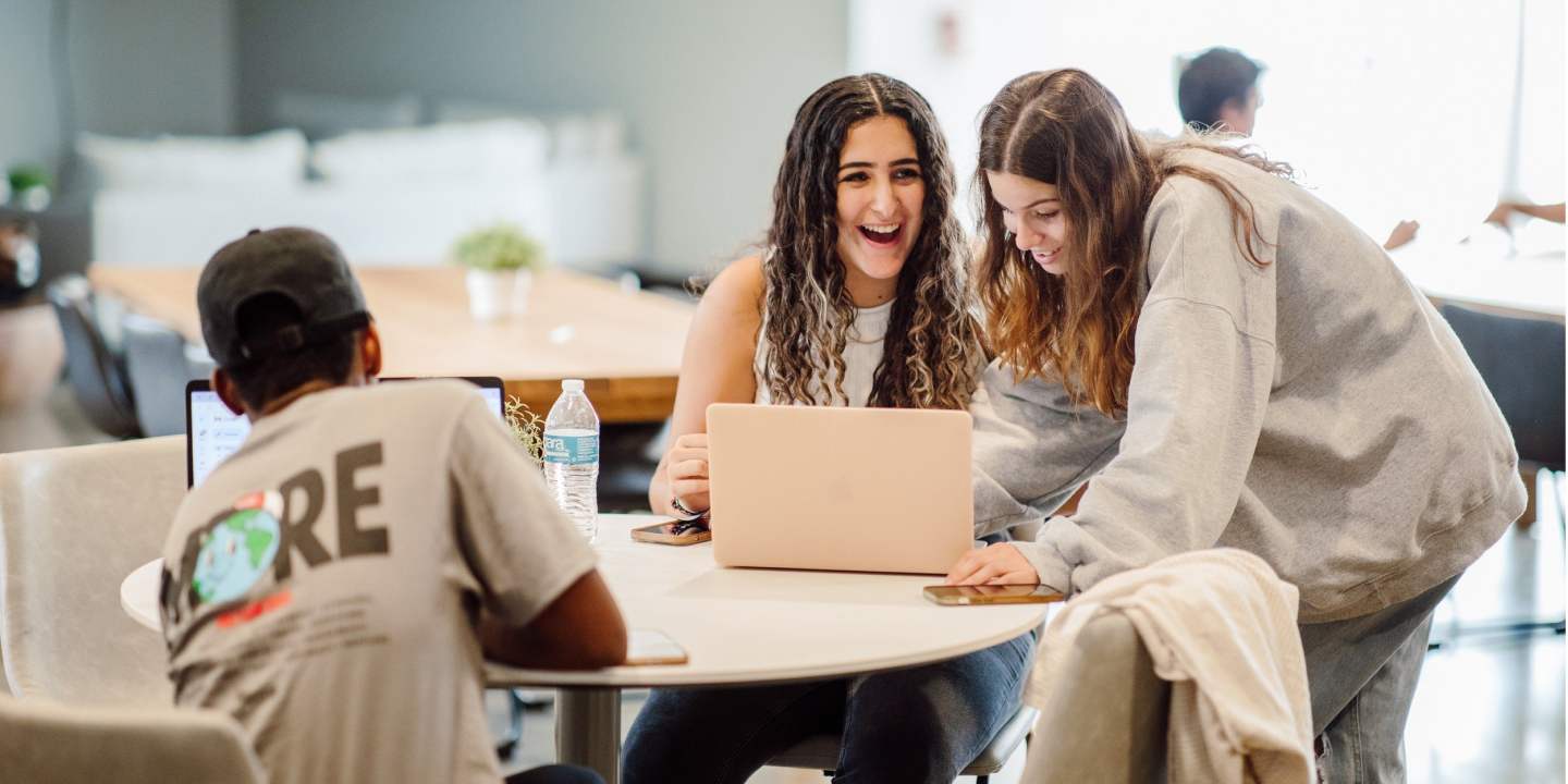 Students laughing together while studying