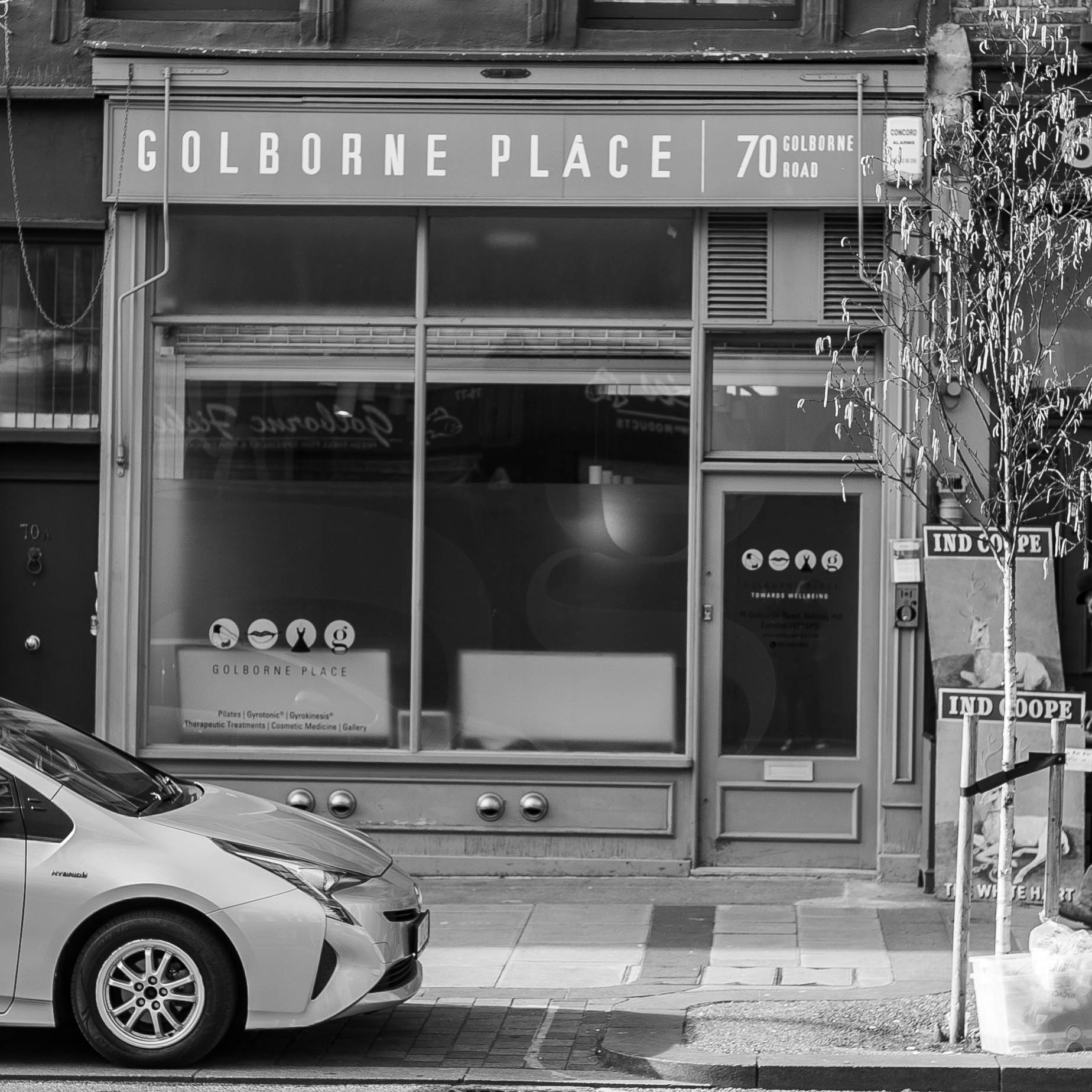 Facade of Golborne Place at 70 Golborne Road with a parked car and a small tree in front.