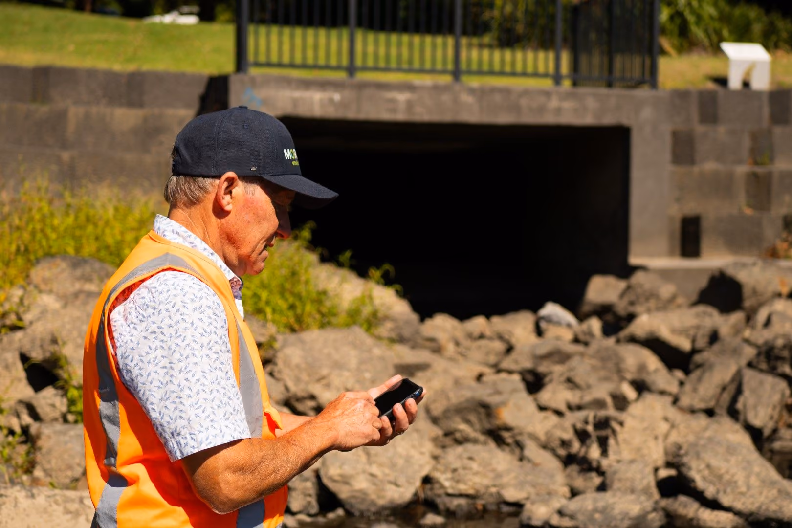A stormwater asset manager assessing a stormwater outlet near the waikato river in New Zealand