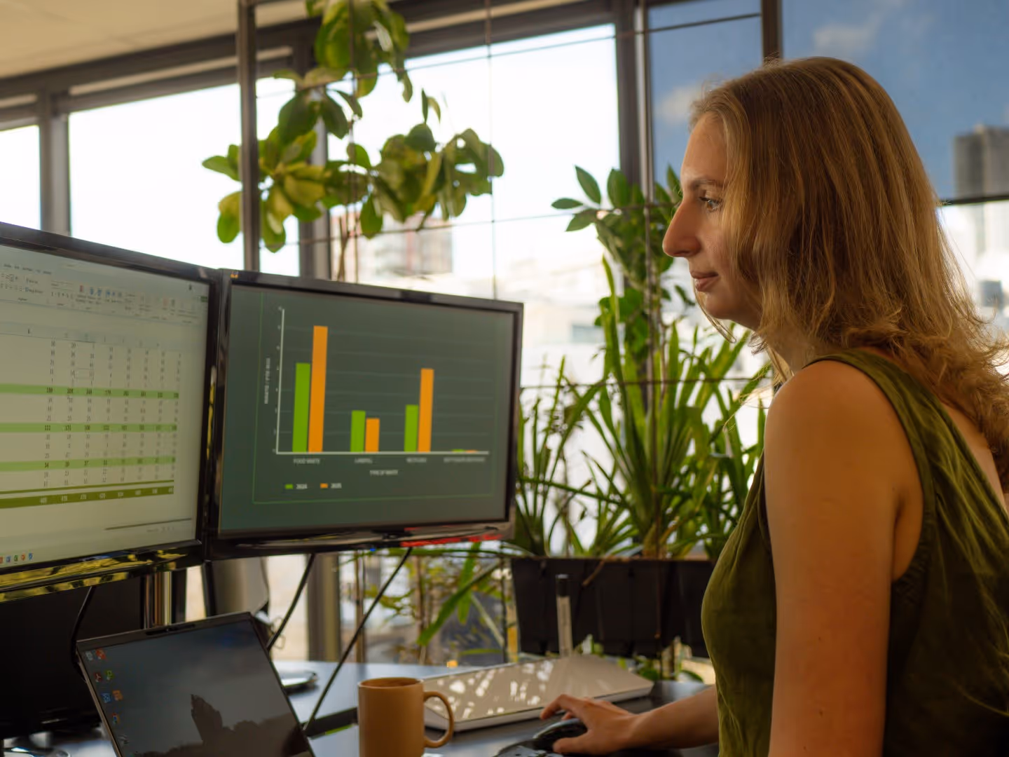 A sustainability consultant looking at statistics from an organisation while working on developing an EMS