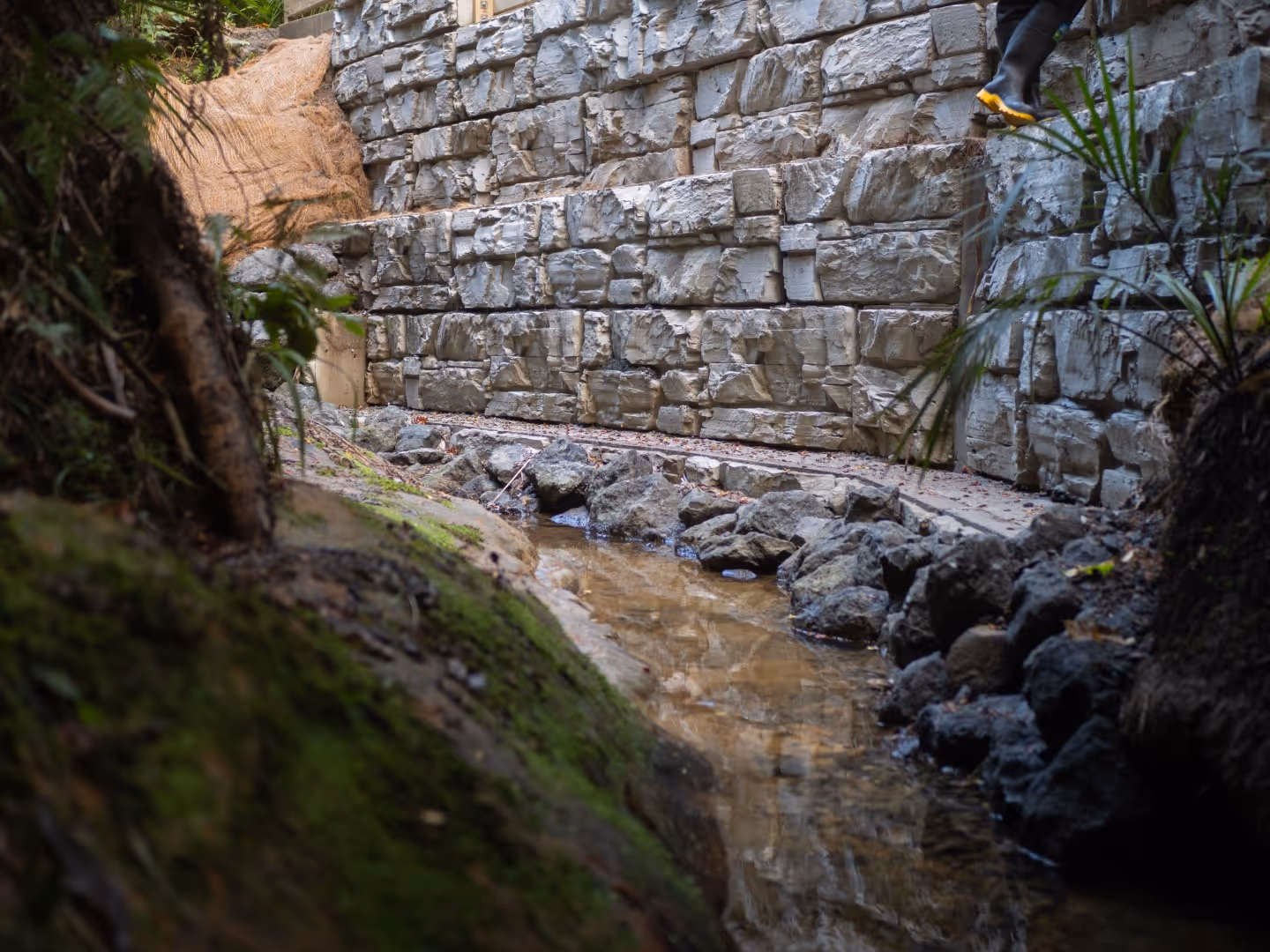 A Morphum Environmental Engineer assessing on ongoing streamworks construction project in Aotearoa following a fluvial geomorphology assessment to prevent landslips