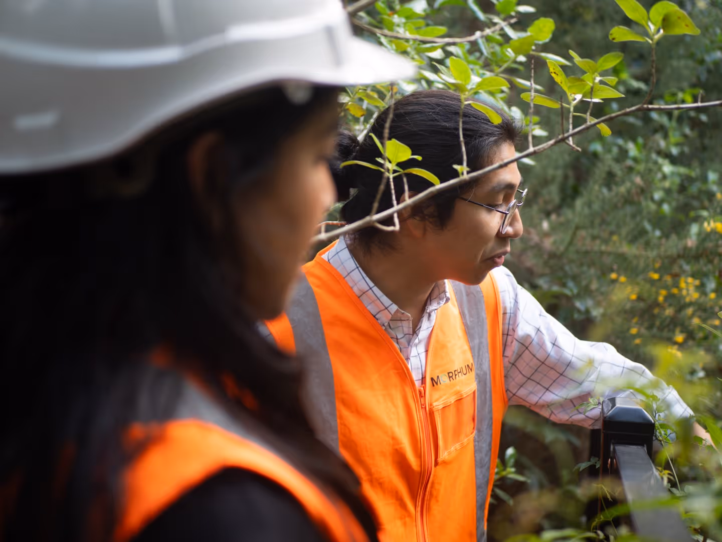 Two Morphum Environmental Engineers wearing high-visibility vests on a construction site assessing a climate adaptation solution that was designed to stabilise vital wastewater infrastructure