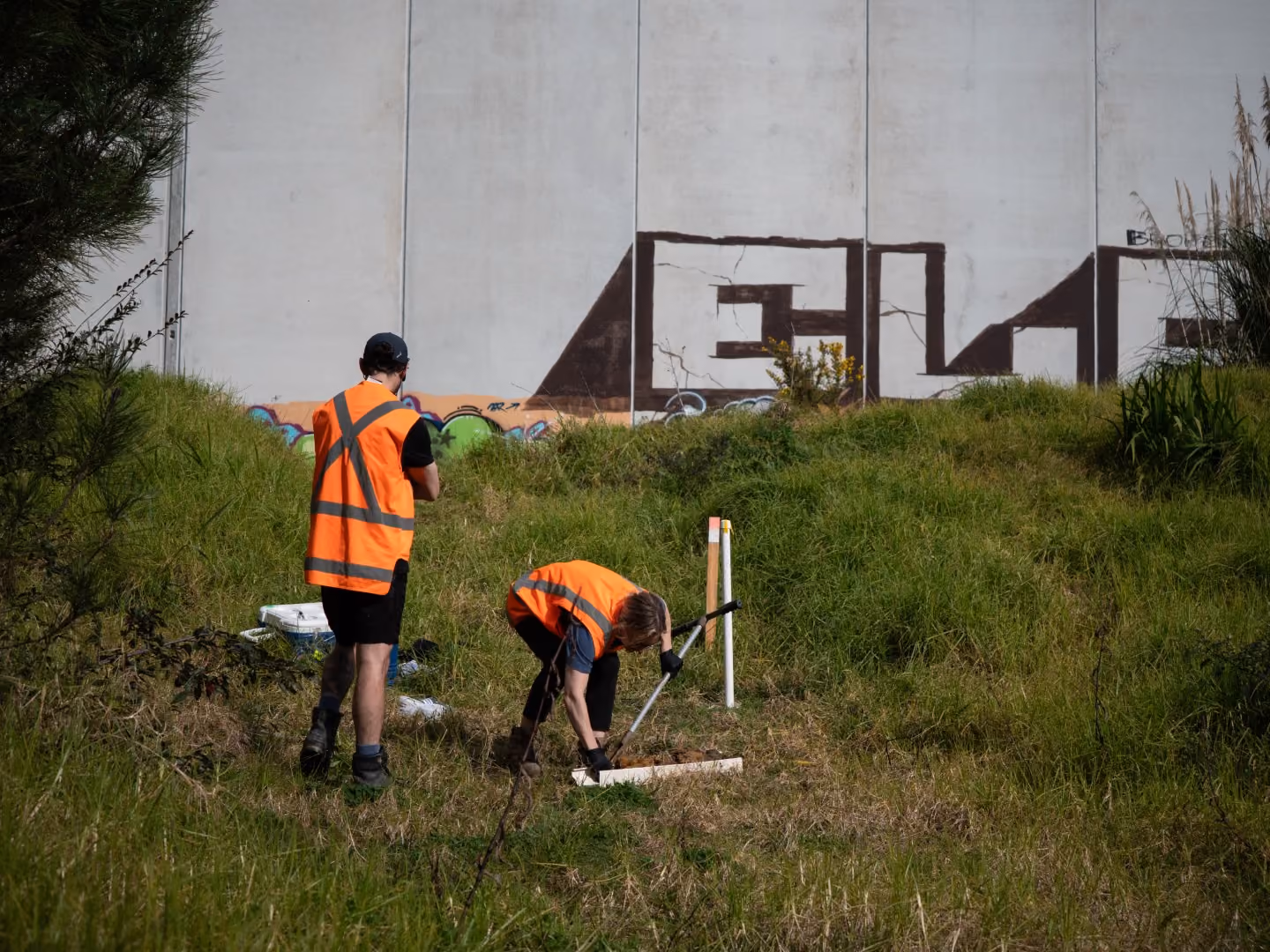 Environmental scientists working in an industrial area to test the soil for contamination as part of a detailed site investigation (DSI) in Auckland