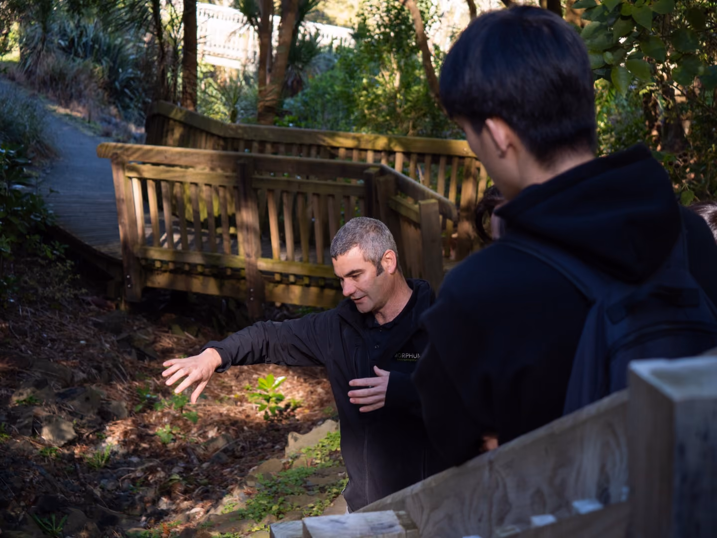 A Morphum Environmental engineer taking a university group for a site visit and sharing in the community education