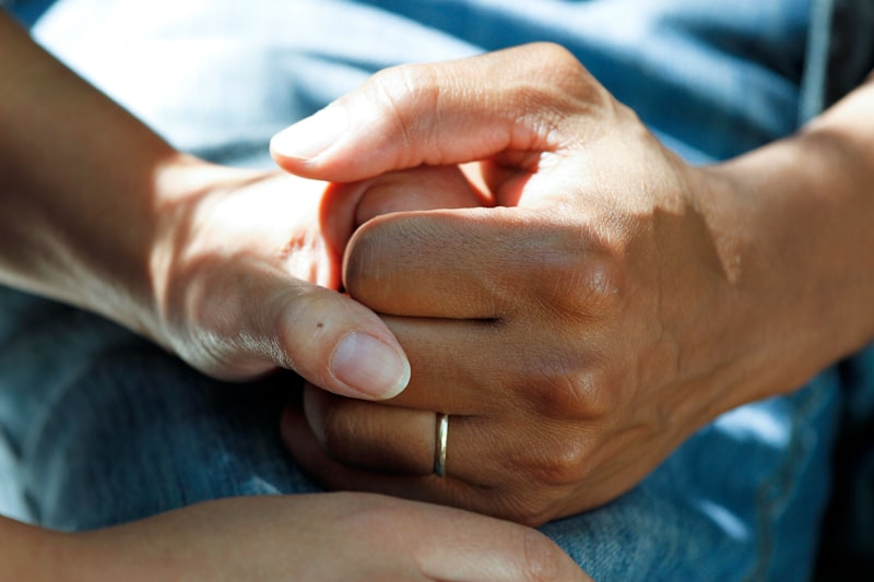 Supportive hands clasping together showing comfort and care