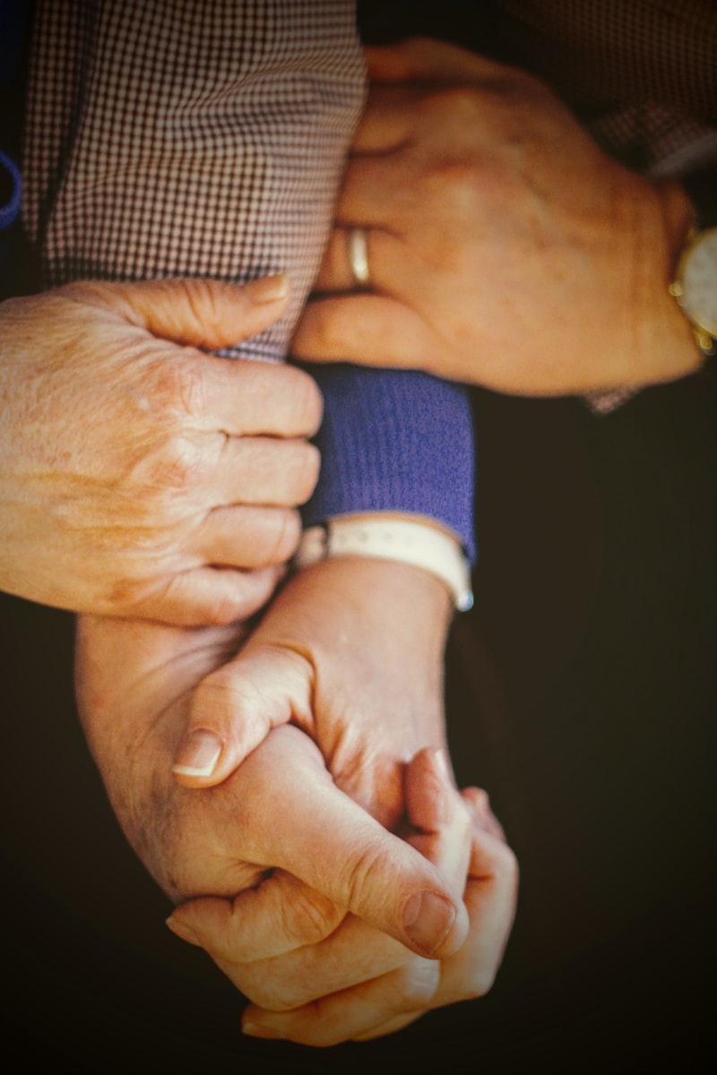 Elderly patient's hands with hospital wristband