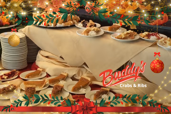 Guests enjoying seafood and waterfront views at Buddy’s Crabs & Ribs in Downtown Annapolis during Memorial Day Weekend, with patriotic decorations and Naval Academy families celebrating nearby.