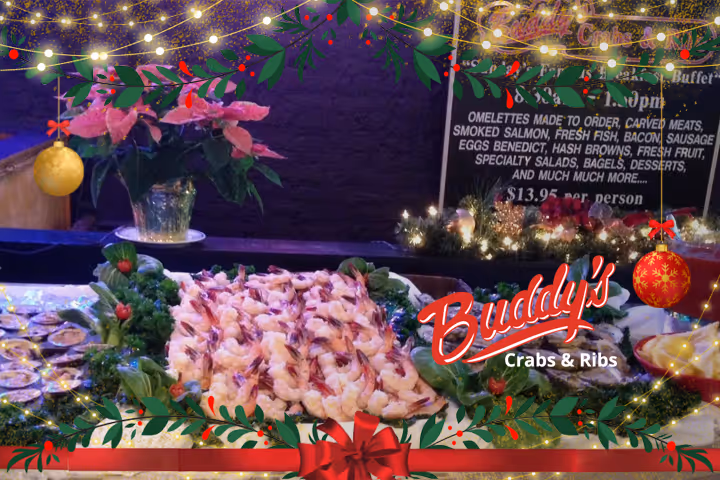 Guests enjoying seafood and waterfront views at Buddy’s Crabs & Ribs in Downtown Annapolis during Memorial Day Weekend, with patriotic decorations and Naval Academy families celebrating nearby.