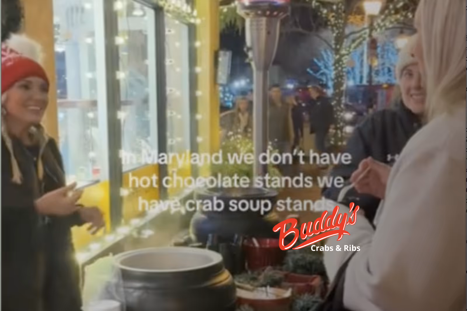 Guests enjoying seafood and waterfront views at Buddy’s Crabs & Ribs in Downtown Annapolis during Memorial Day Weekend, with patriotic decorations and Naval Academy families celebrating nearby.