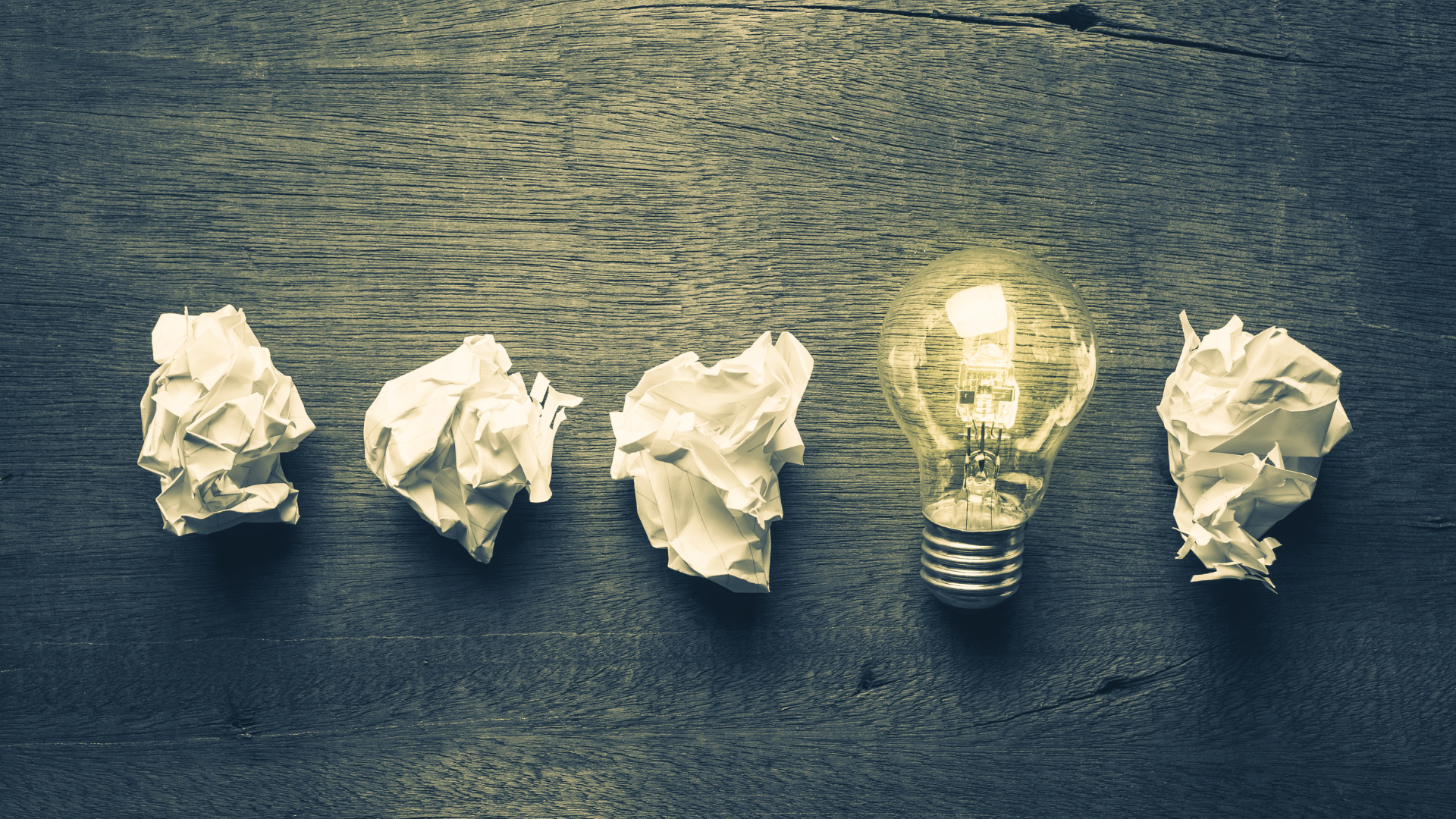 Lightbulbs and crumpled paper representing ideas.