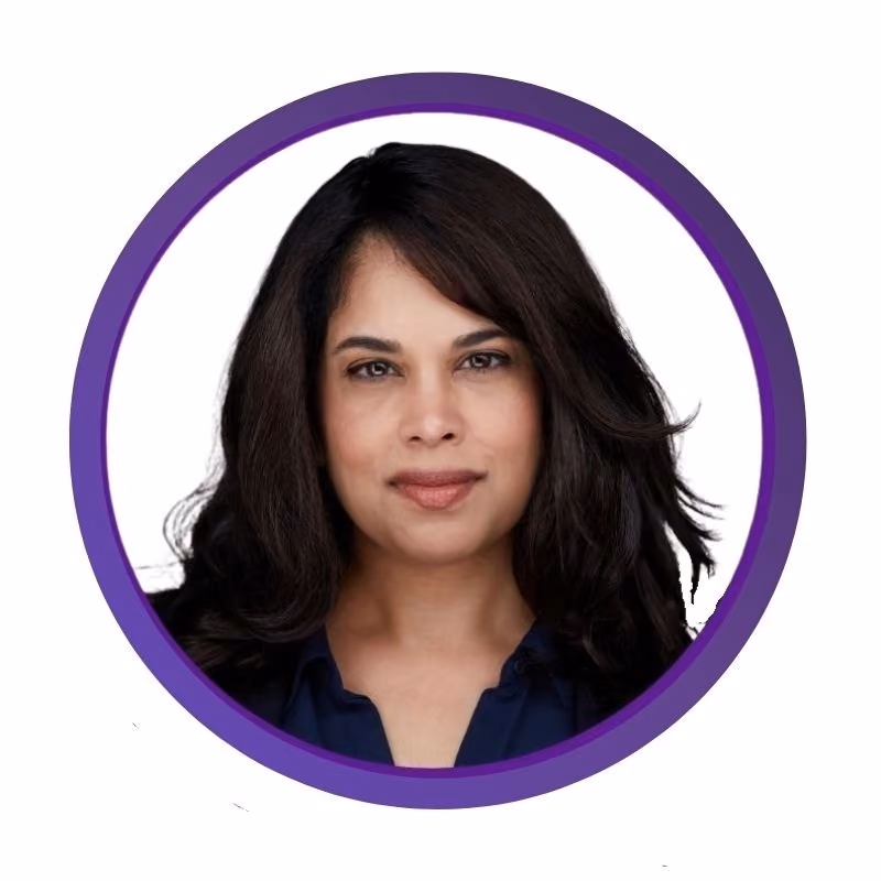 Headshot of a woman with medium-length dark hair, wearing a dark blue top, framed by a purple circular border.